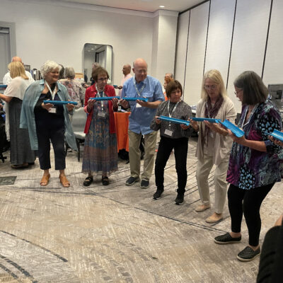 Participants working together to complete a challenge the 'Clean Water Connection' team building event. thumbnail