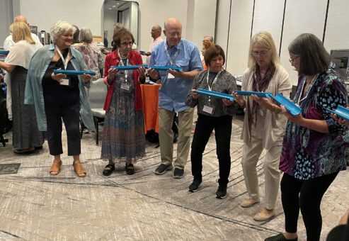 Participants working together to complete a challenge the 'Clean Water Connection' team building event.