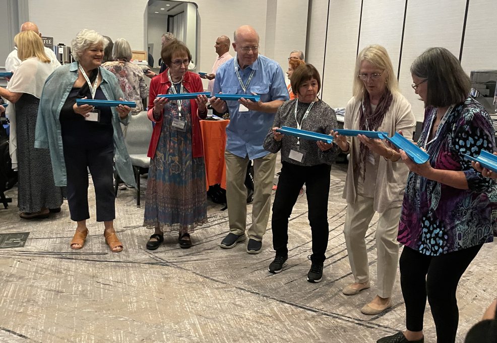 Participants working together to complete a challenge the 'Clean Water Connection' team building event.