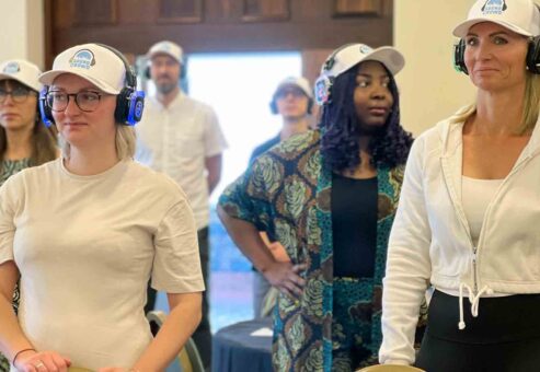 A group of participants in a Sound Crowd team building event stand attentively while wearing noise-cancelling headphones. The activity encourages non-verbal interaction, using sound and movement to foster connection, teamwork, and enthusiasm in a unique way.