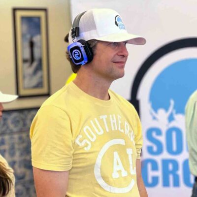 A group of participants in a Sound Crowd event stand attentively while wearing noise-cancelling headphones. They are participating in a team building event that focuses on non-verbal communication. thumbnail