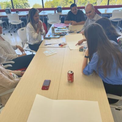 Team members engage in a creative brainstorming session during a team building event, fostering collaboration and innovative thinking. thumbnail