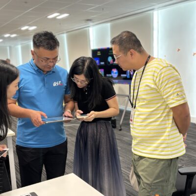 This image showcases a team building event where participants work collaboratively, utilizing tablets to coordinate and create their AI-driven broadcast, exemplifying effective teamwork and communication. thumbnail