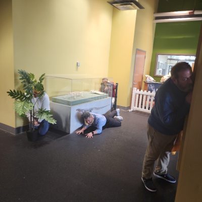 Team members engaging in a fun and interactive museum scavenger hunt. They work together to solve clues, exploring the exhibit while using creative problem-solving and teamwork. thumbnail