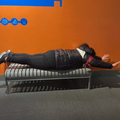 Team member participating in a fun optical illusion at the Museum of Illusions during a scavenger hunt. The interactive exhibit encourages creativity and problem-solving as they navigate the illusions with the team. thumbnail