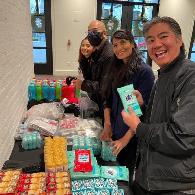 Team members organizing essential items for disaster relief care kits during the Team Disaster Relief event. They are collaboratively preparing supplies, including snacks and hygiene products, to support recovery efforts. thumbnail