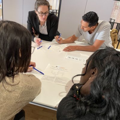 Team members collaborating and problem-solving during the Team Disaster Relief event, working together to plan and assemble disaster relief care kits. The activity emphasizes teamwork and communication skills. thumbnail