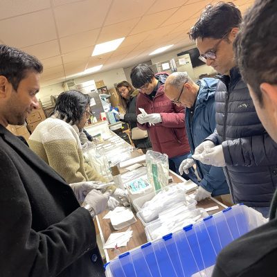 Team members assembling disaster relief care kits during the Team Disaster Relief event, carefully preparing essential supplies while working together to support those in need. thumbnail