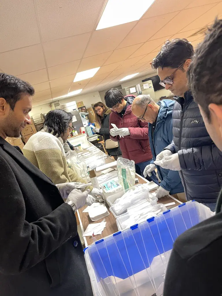 Team members assembling disaster relief care kits during the Team Disaster Relief event, carefully preparing essential supplies while working together to support those in need.