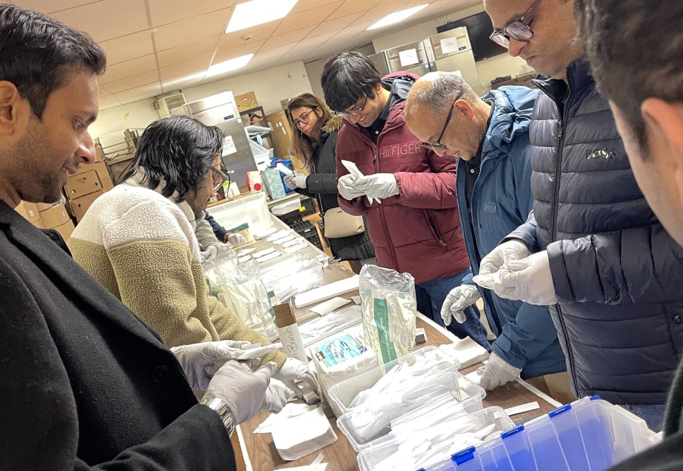 Team members assembling disaster relief care kits during the Team Disaster Relief event, carefully preparing essential supplies while working together to support those in need.