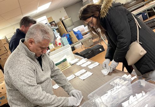 Team members working together to organize and prepare items for disaster relief care kits during the Team Disaster Relief event. The activity fosters collaboration and teamwork while making a real-world impact.