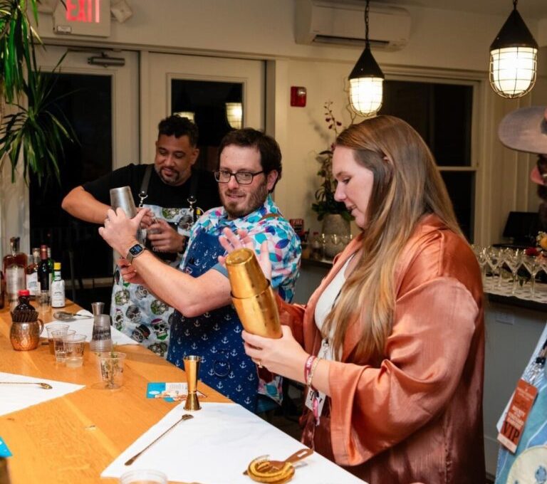 Team members shaking up cocktails during a mixology class. This fun and interactive team building event encourages collaboration, creativity, and the art of crafting delicious drinks.